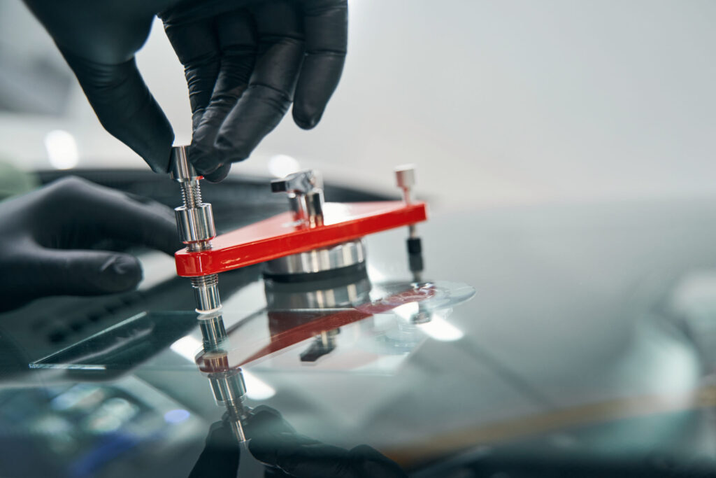 tech using windshield repair tool - windshield chip repair